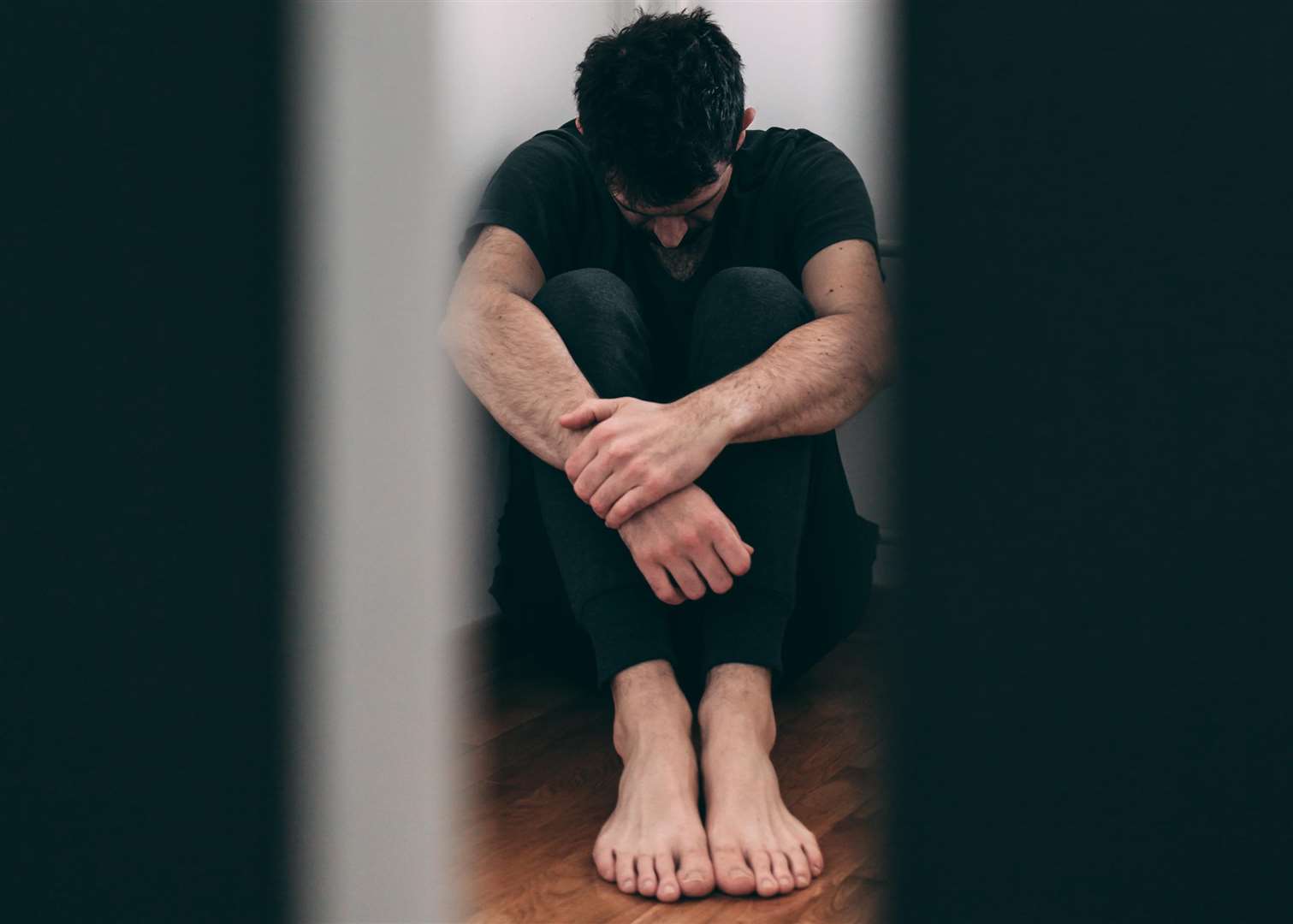 Man sitting alone and depressed after abuse. Getty Images