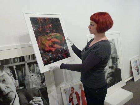 Tunbridge Wells Museum's Rachel Heminway-Hurst putting up Lord Snowdon's work, ready for the exhibition