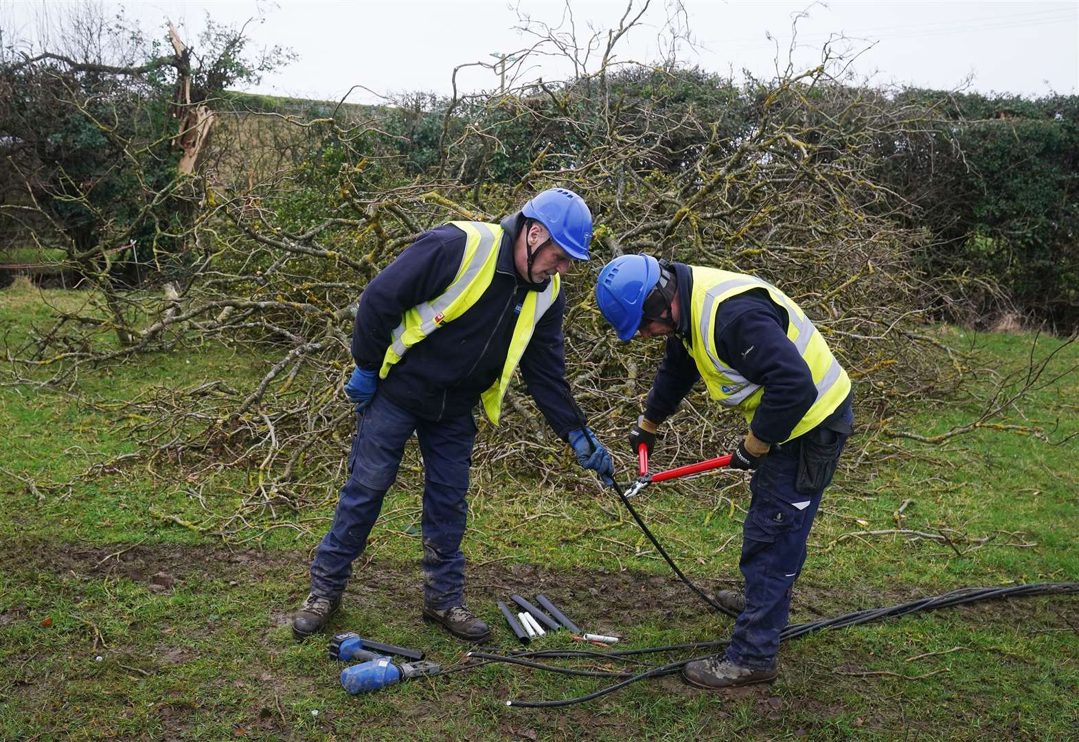 ESB Network technicians Dave Darcy (left) and Chris Doherty work to restore power (Brian Lawless/PA)