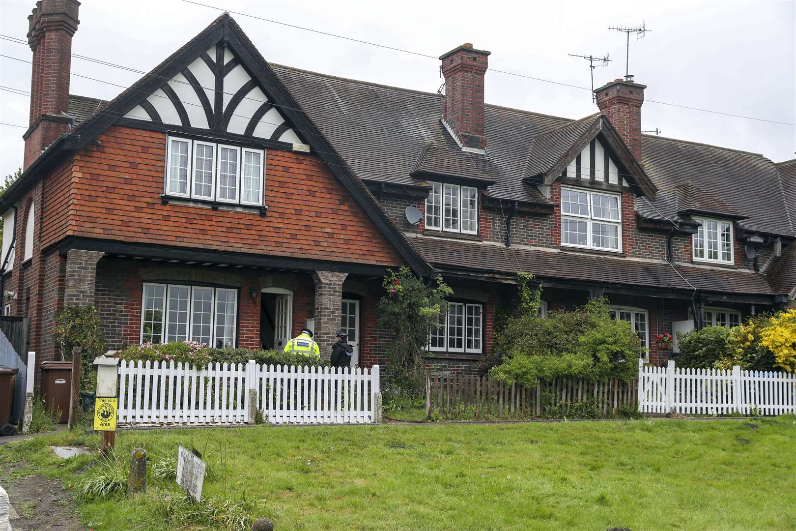 Surrey Police officers conduct house to house enquires on the A25 Bletchingley Road, Godstone, near Reigate, after 88-year-old man was found dead in a home (Steve Parsons/PA)