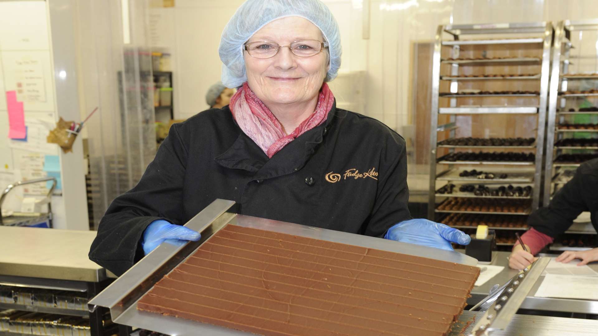 Wendy Adcock operates a fudge slicing machine