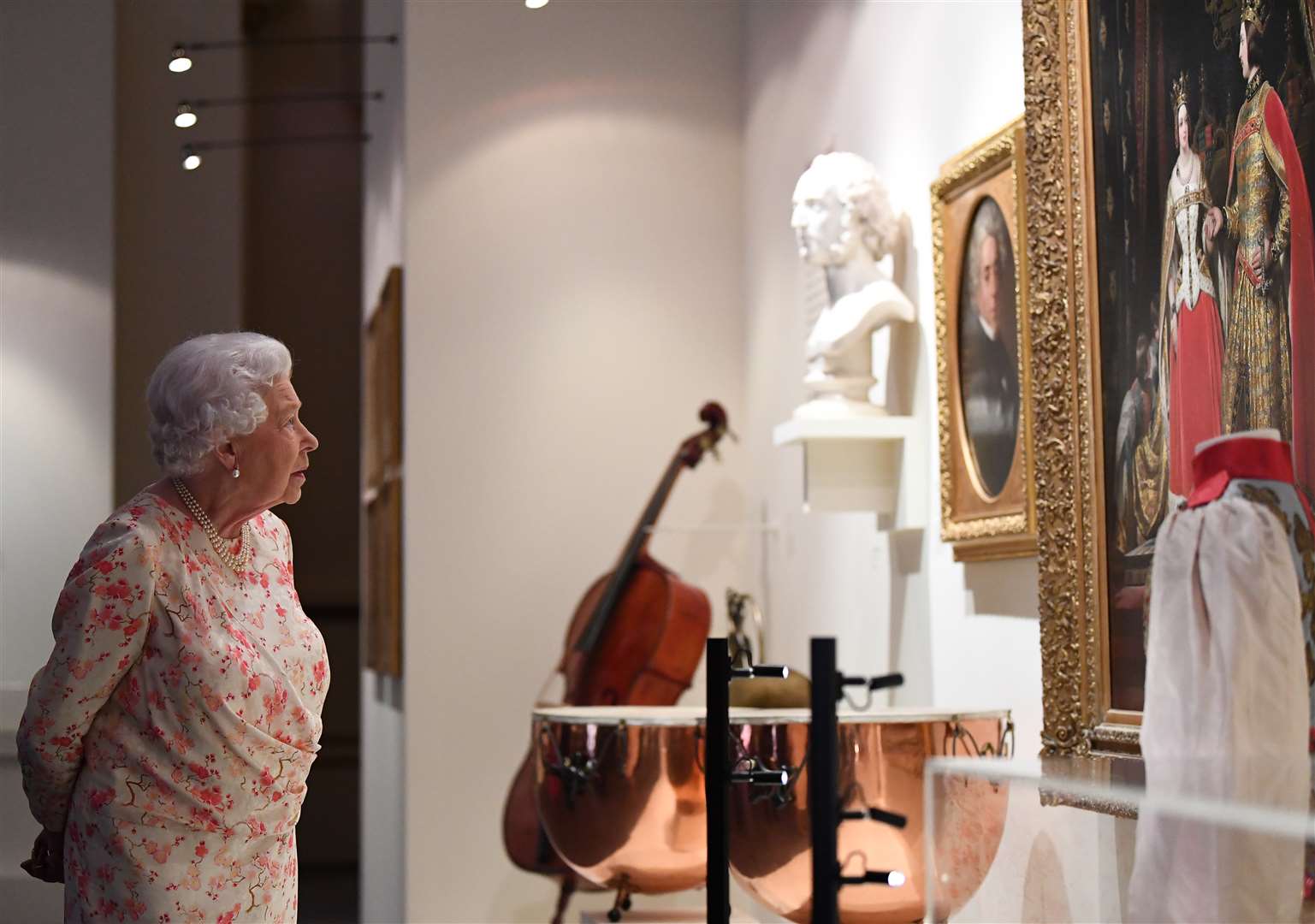 The Queen views an exhibition to mark the 200th anniversary of the birth of Queen Victoria ahead of the Summer Opening of Buckingham Palace in 2019 (Victoria Jones/PA)