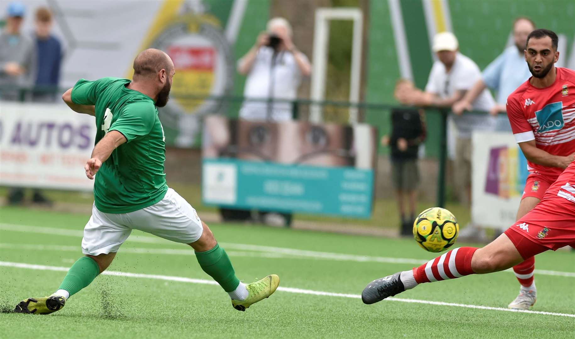 Adem Ramadan slots home Ashford United’s third goal against Egham Town on Saturday. Picture: Ian Scammell