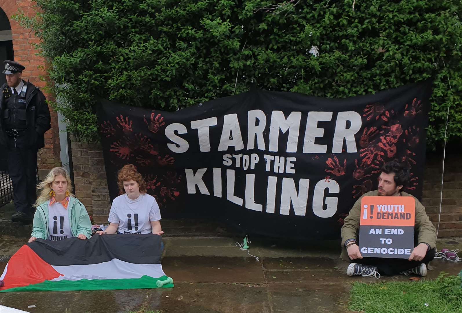 Lewis, left to right, Ward and Formentin hung a banner outside Sir Keir’s house during their protest (Youth Demand/PA)