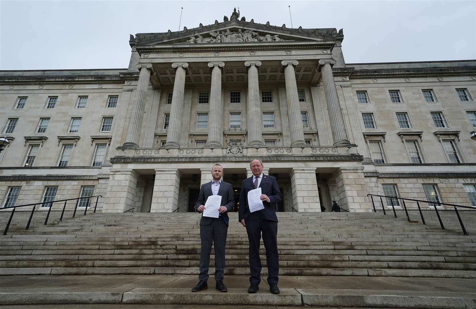 Loyalist activist Jamie Bryson (left) and TUV leader Jim Allister stand outside Stormont (Brian Lawless/PA)