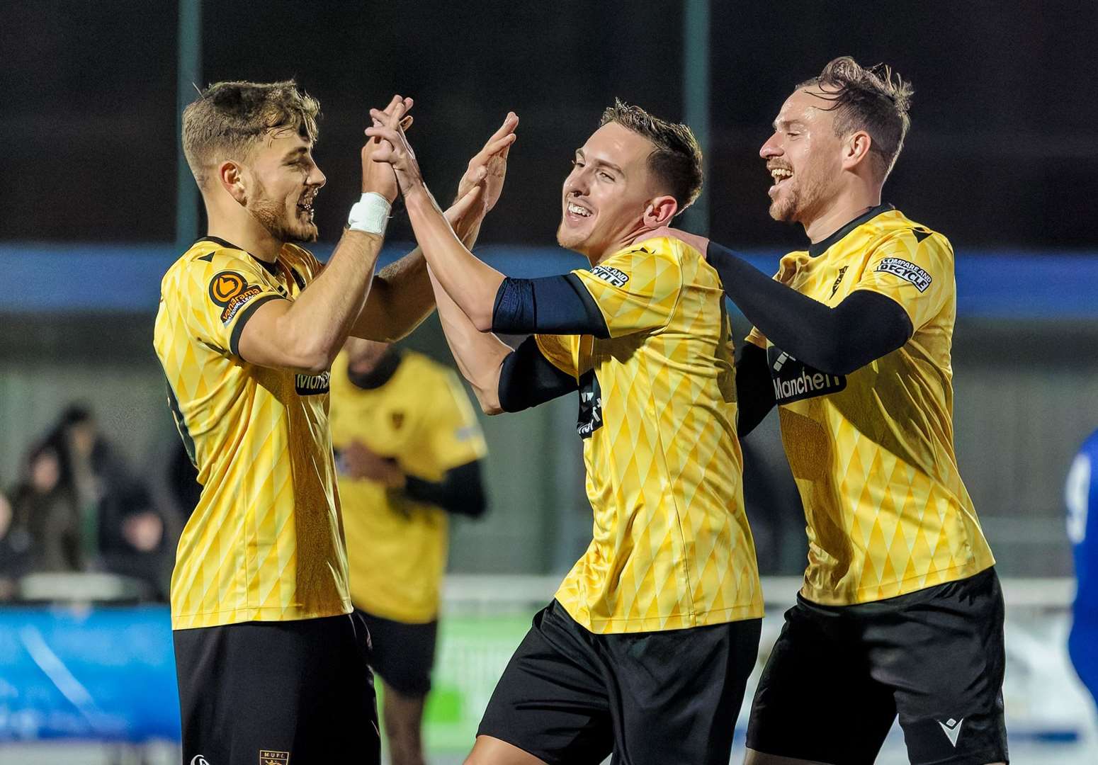 Maidstone forward Matt Rush, centre, celebrates with Antony Papadopoulos and Jordan Higgs after opening the scoring at Aveley.