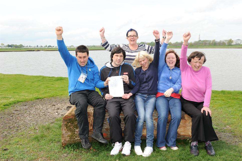 Paul Braby with his sculpture design, Lewis Shepherd, Mandy Shade - Park manager, Caz White - support worker, Emma Stratton, Vanessa Kitto, with the log that will be used for the sculpture