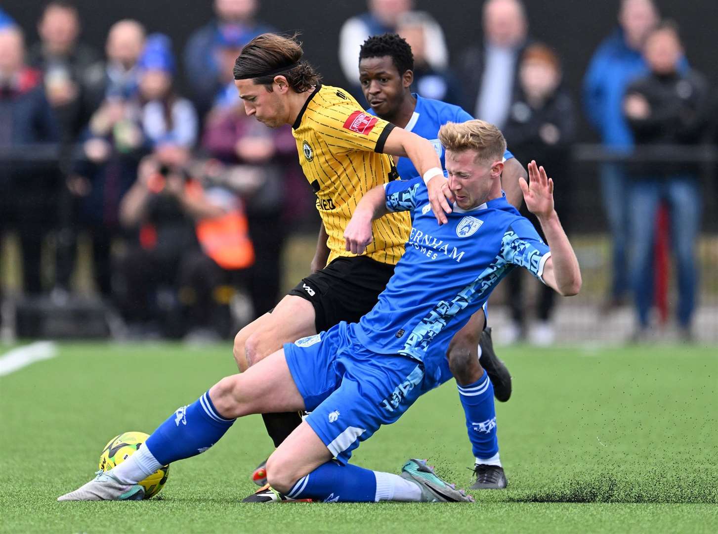 Tonbridge’s Ryan Hanson slides in on Cray Wanderers’ Charlie Edwards on Saturday. Picture: Keith Gillard