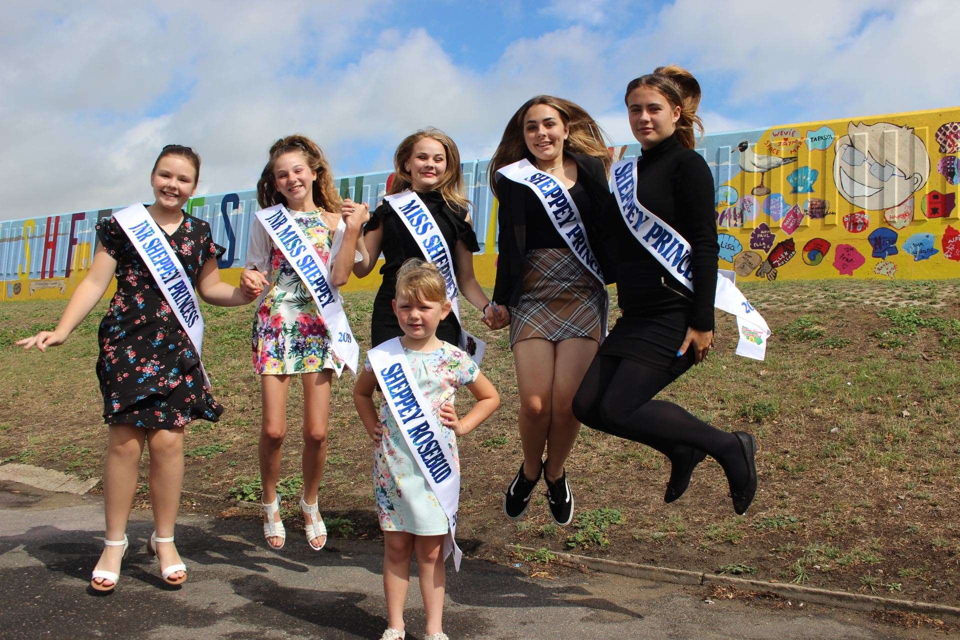 Sheppey carnival girls jumping for joy as they prepare for their big parade on Saturday. From the left, Lois Kidd, 10, Keira Collins-Kiazia, 13, carnival queen Melody Jackson, 15, Darcey Kidd, 14, and Paige Heaton, 14, with Sheppey Rosebud Evie Bowes, 5, in the front. Picture: John Nurden (15016559)