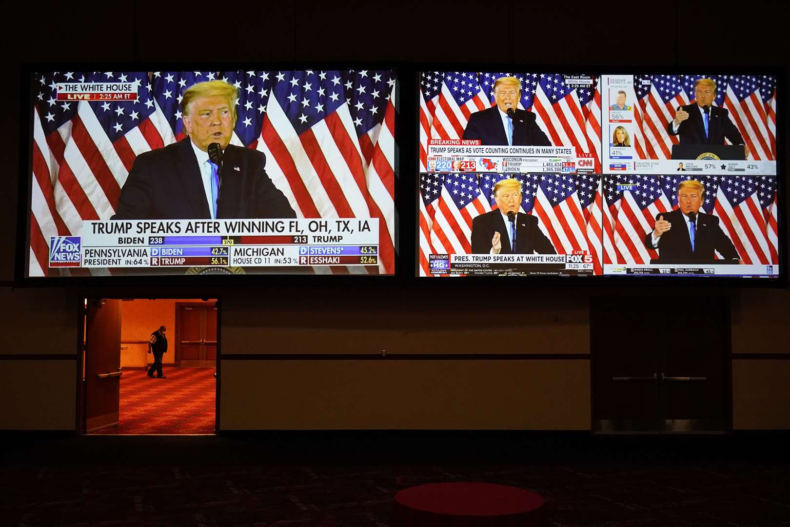 A live broadcast of Trump speaking from the White House is shown on screens at an election night party in Las Vegas (John Locher/AP)