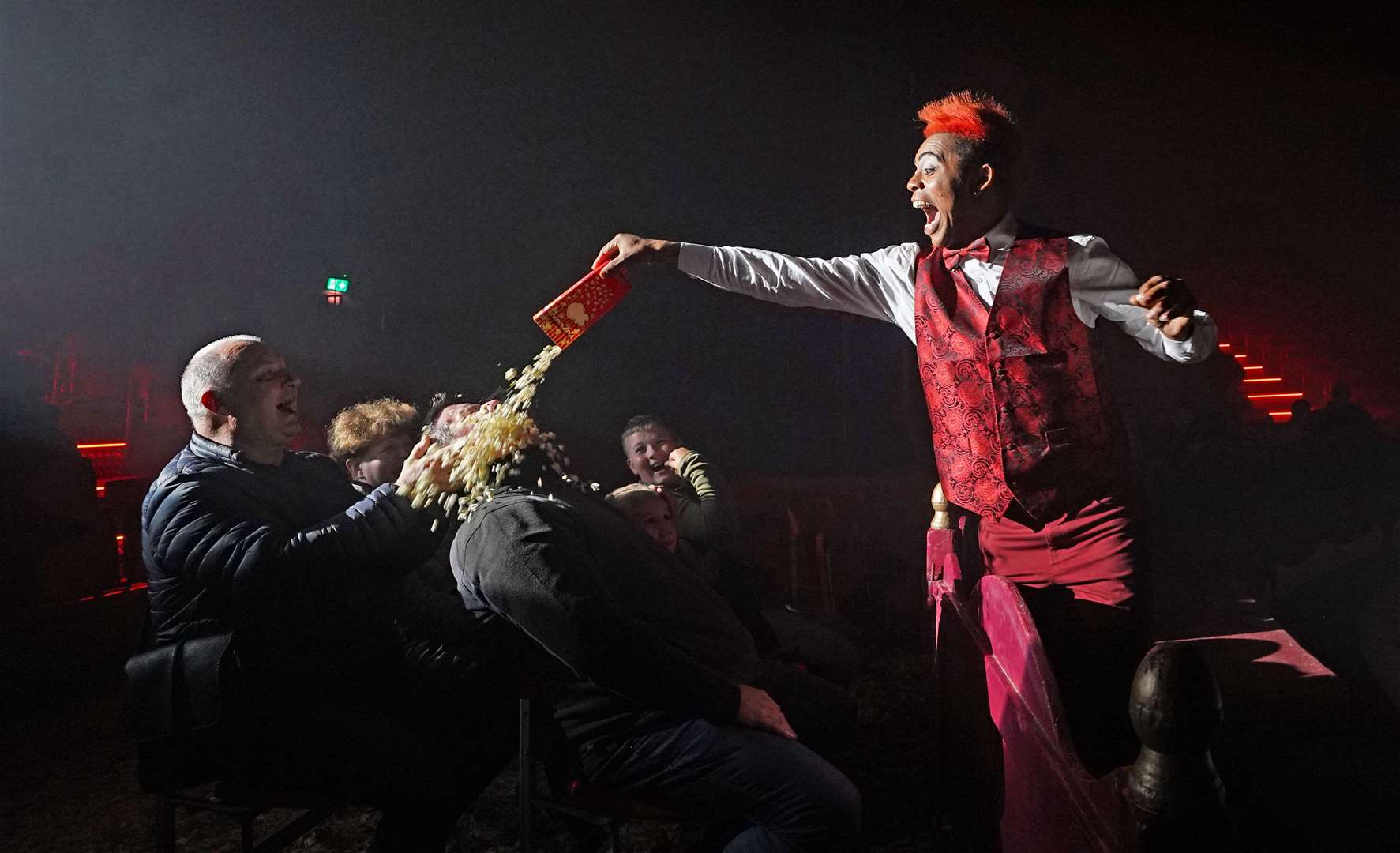 Walison the Clown empties popcorn over an unsuspecting member of the audience during a performance by Tom Duffy’s Circus in Drogheda (Niall Carson/PA)