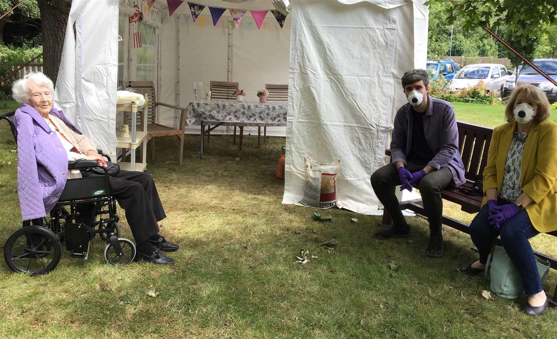 Resident Rita Forder meeting her family outside the gazebo, which will soon be replaced by a log cabin Picture: Rapport Housing & Care