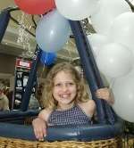 READY FOR TAKE OFF: Lucy Pryoe, nine, from Biddenden, at the Skybus Ballooning stand. Picture: JOHN WARDLEY