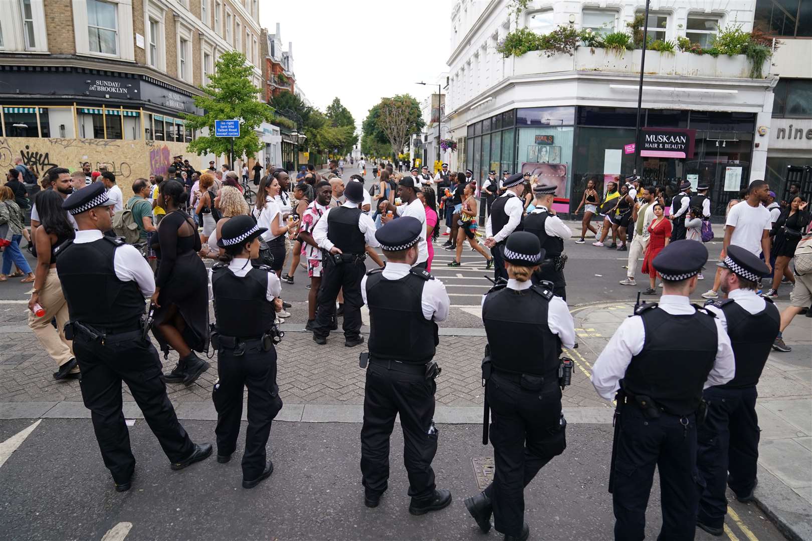 Police watch the parade (Kirsty O’Connor/PA)