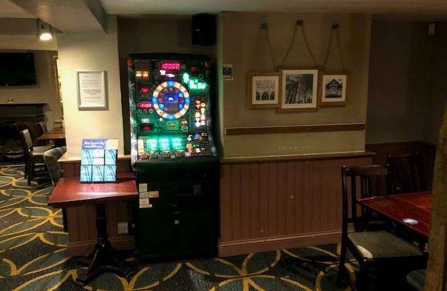 Blinking away on one side of the bar, you'll find this fruit machine