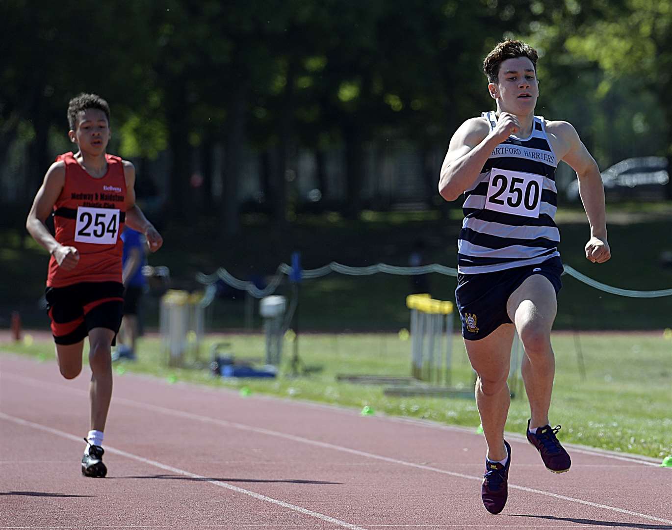 Brandon Nathan of Dartford Harriers (No.250) gets ahead of M&M's Lucas Cameron in the under-15 boys' 300m. Nathan was second in the race for glory but set the gold standard in the hammer with a winning throw of 41.52m. Picture: Barry Goodwin (56694969)