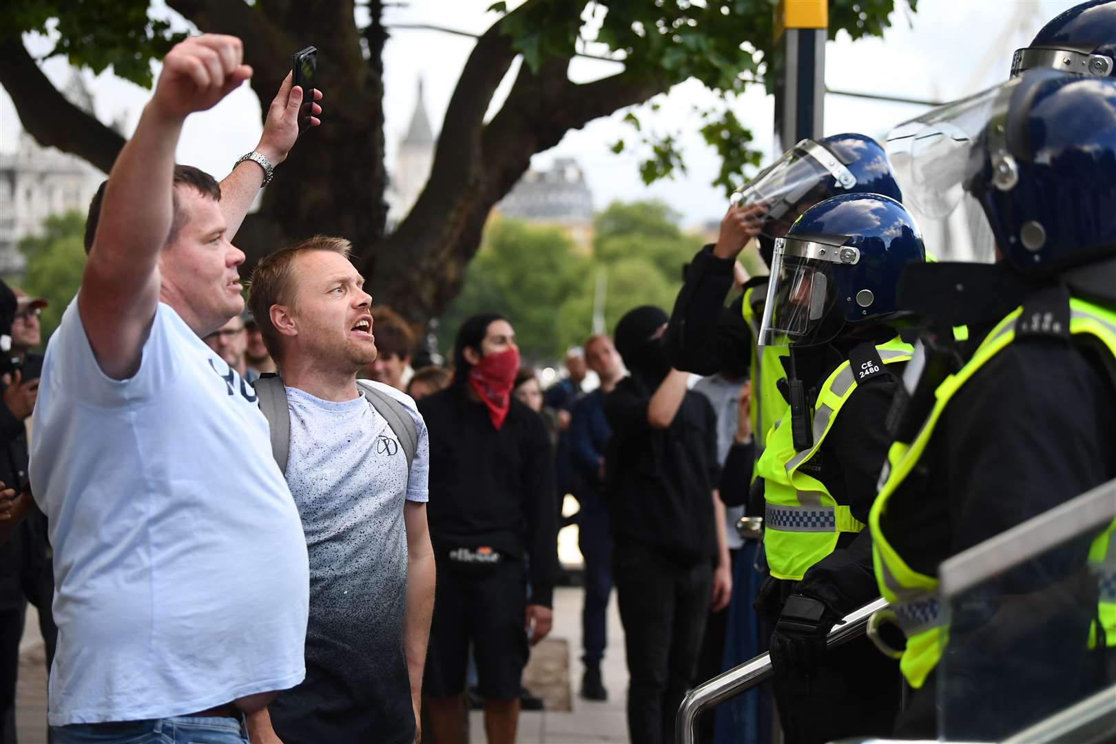 Protesters alongside police officers at Waterloo Station in London (Victoria Jones/PA)