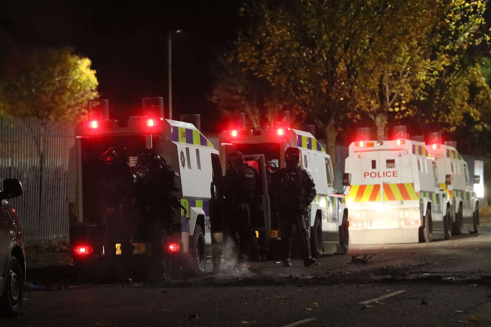 Police officers in riot gear by their vehicles near to the Loyalist Shankill Road during a protest against the Northern Ireland Protocol. (Brian Lawless/PA)