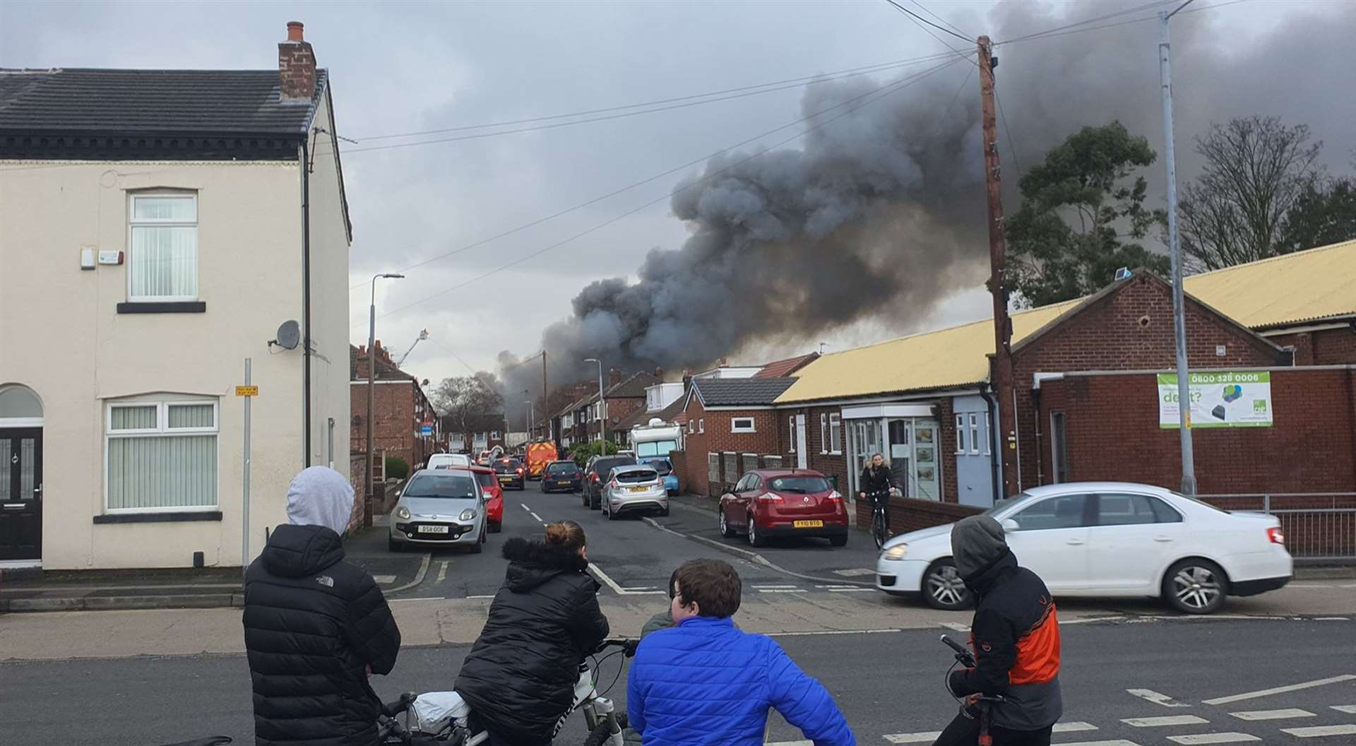 Smoke rises from a fire at a three-storey warehouse in Holland Street, Denton, Manchester (Brian Jones/PA)