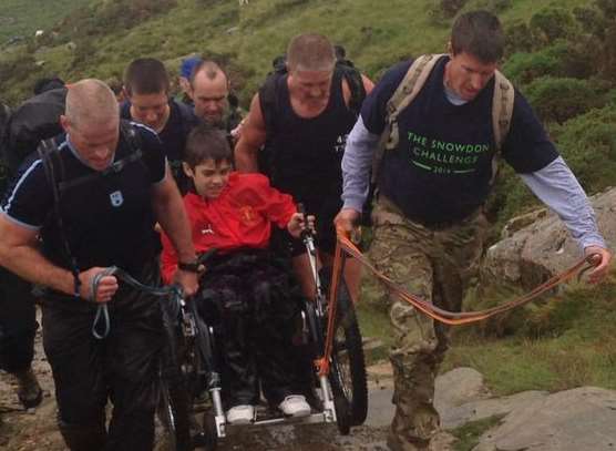 Jake had a little help during the ascent of Snowdon from family and police officers