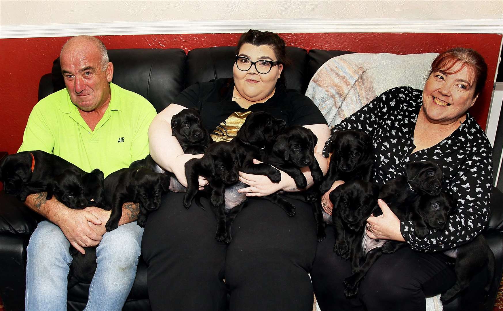 (From left) Nick, Leah and Esther Barrett holding their litter of 13 Labrador puppies at their home at Allhallows. Picture: Sean Aidan (19571945)