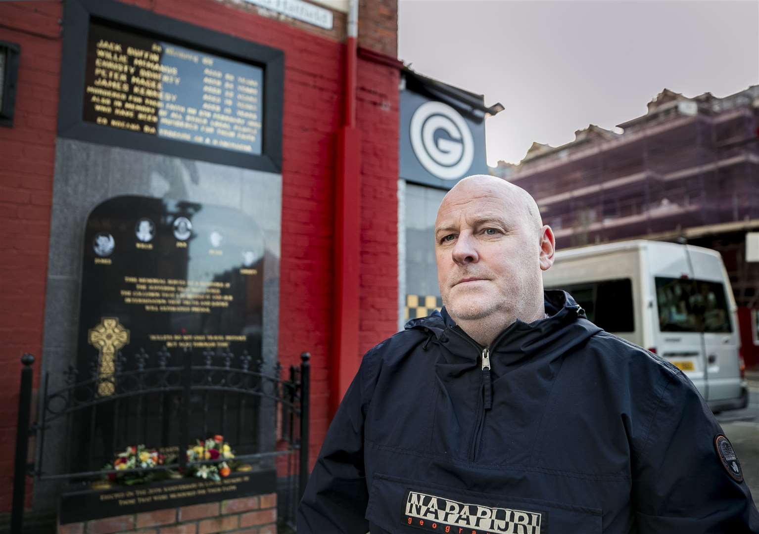 Mark Sykes stands at the memorial to those killed at the Sean Graham bookmakers shop (Liam McBurney/PA)