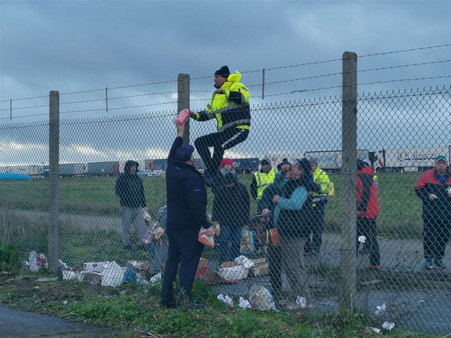 Food is passed to lorry drivers stranded at Manston Airport yesterday