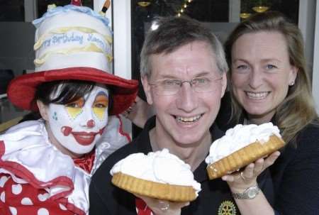 Kent Messenger Group chairman Geraldine Allinson and clown Donna Wells Area Fund Raiser Manager of Demelza House, throw a custard pie in the face of the Rotary District Governor, Denis Spiller to help launch the Rotary Fun Day