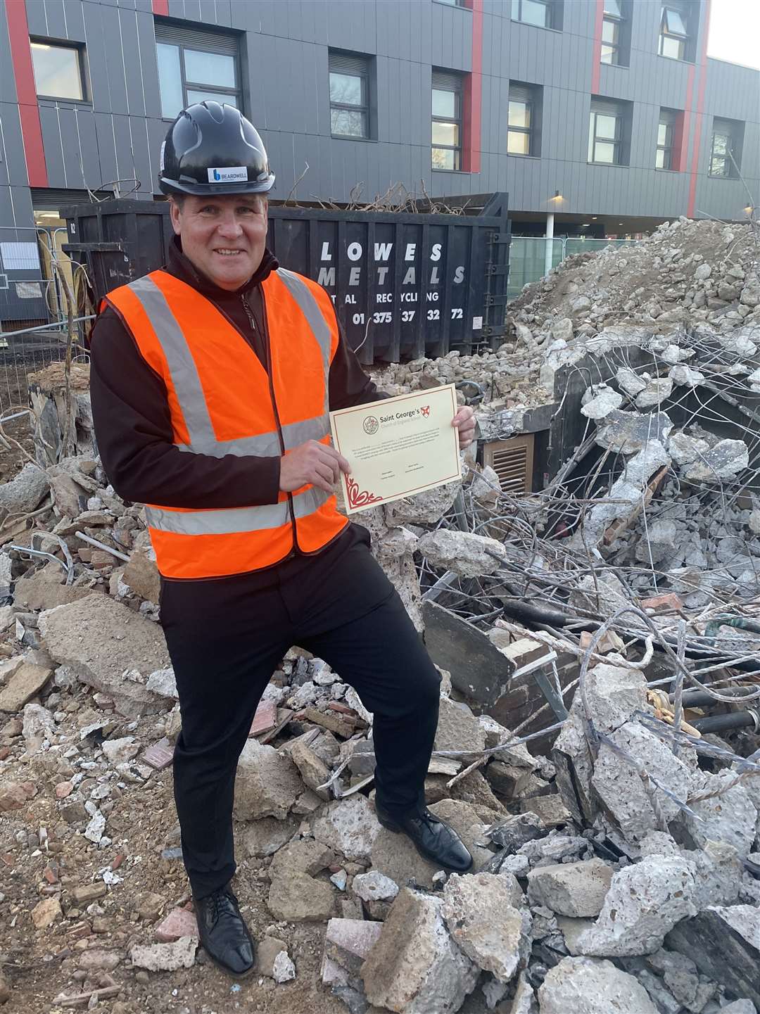 Head teacher Steve Carey with the demolished buildings. Picture: Matt Joblin / JustGiving