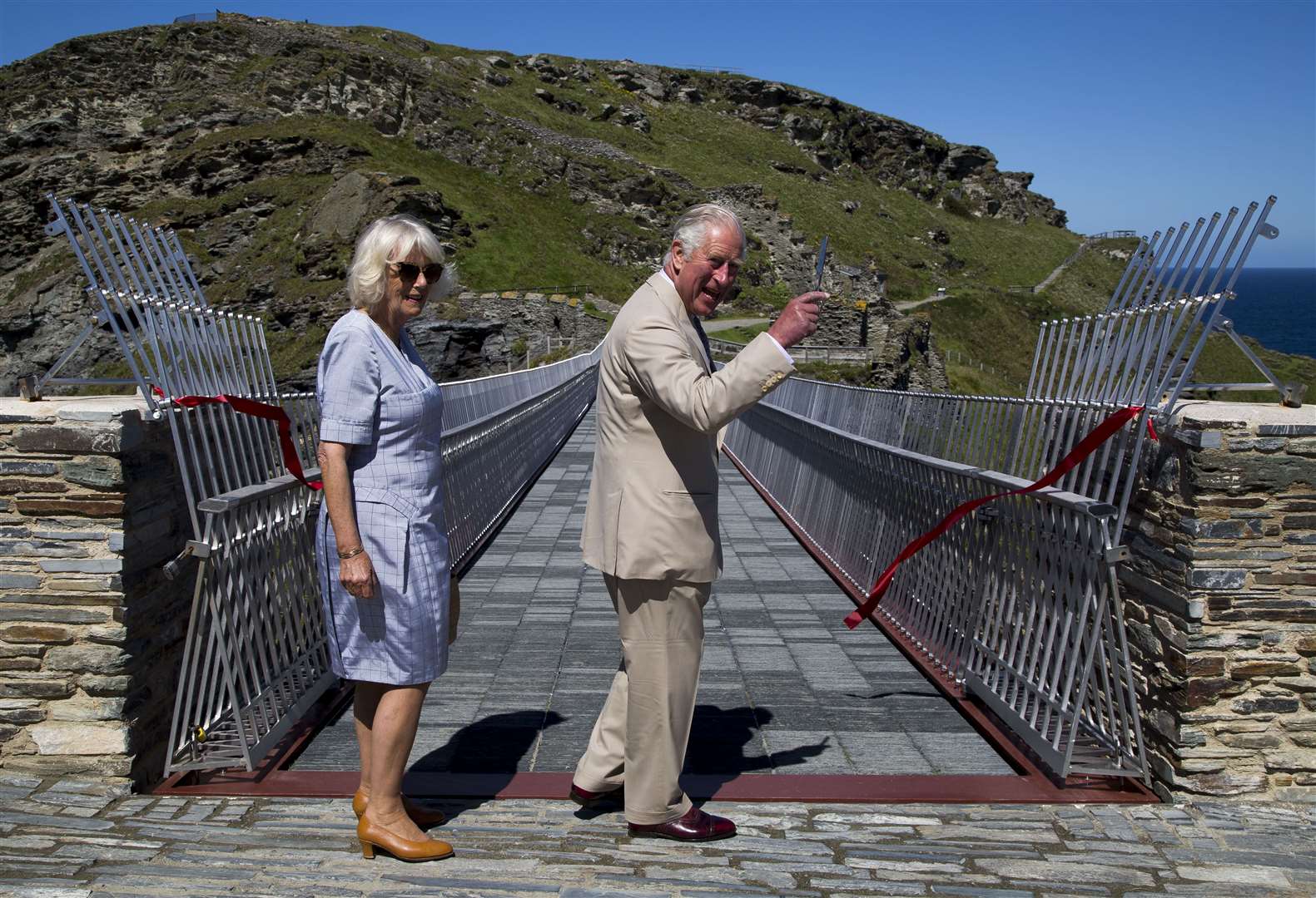 Charles cuts the ribbon to officially open the walkway (Geoff Caddick/PA)