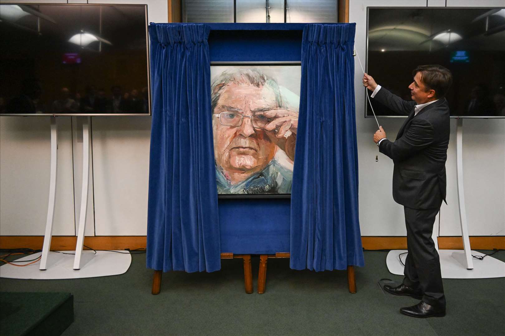 John Hume Jr unveils the portrait of his late father (UK Parliament/Jessica Taylor/PA)