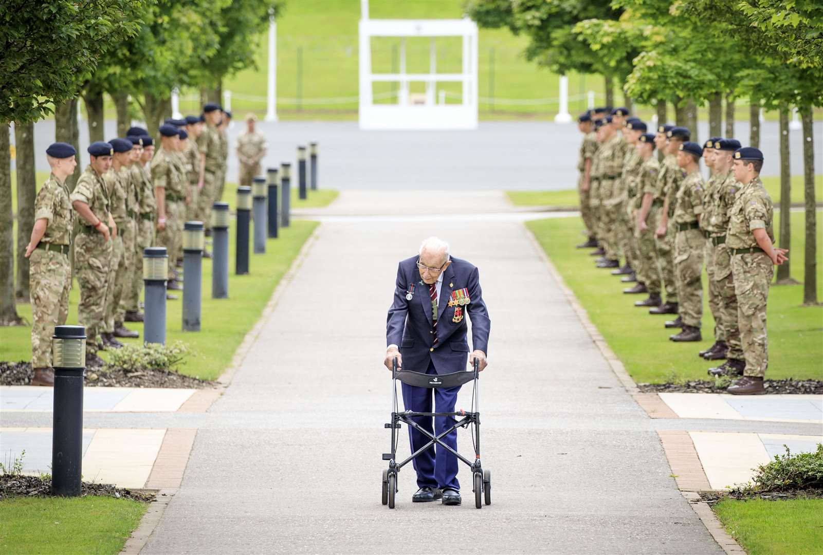 Captain Sir Tom Moore walking down a guard of honour during a visit to the Army Foundation College in Harrogate (Danny Lawson/PA)