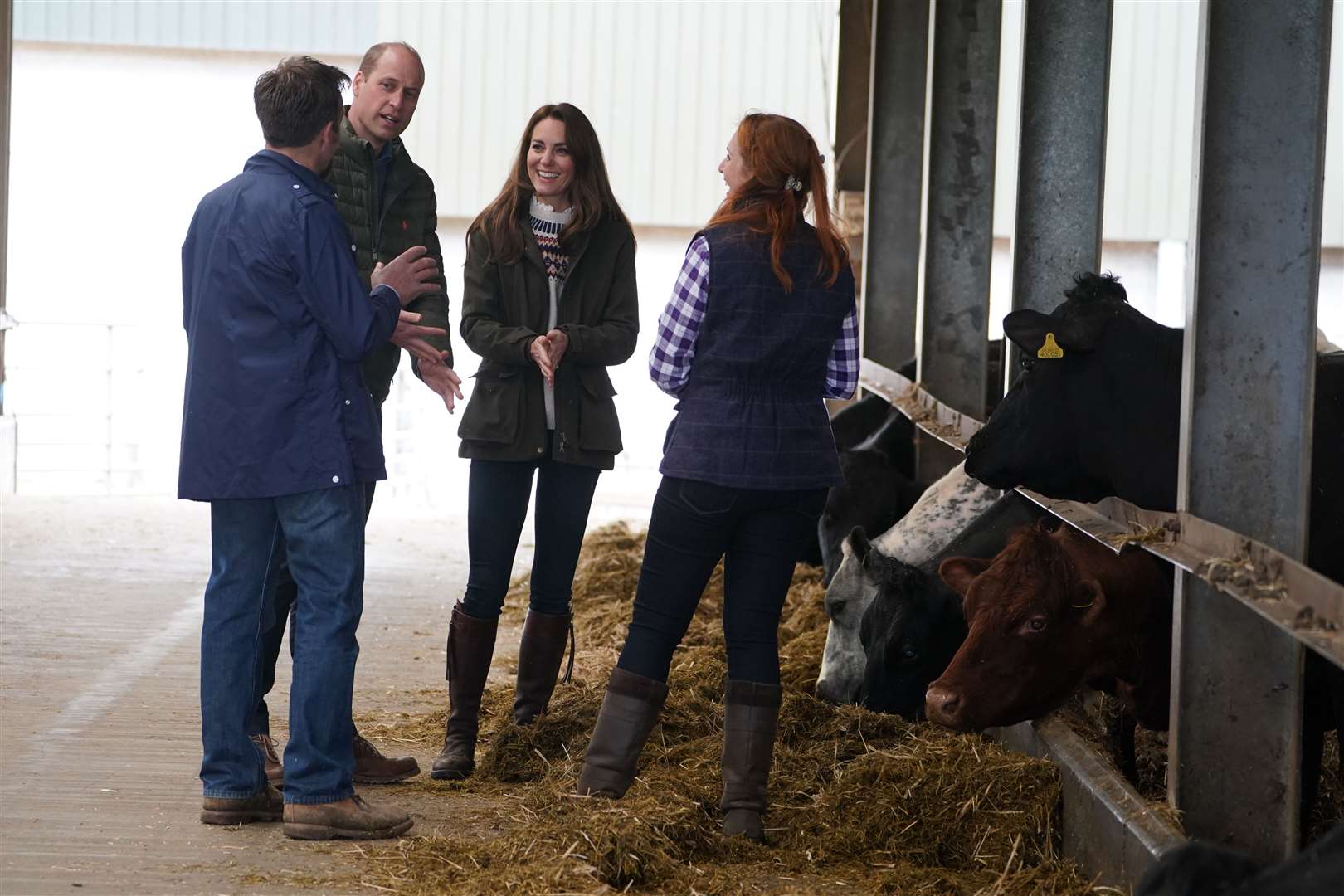 The Duke and Duchess of Cambridge (centre) are shown cattle by farmers Stewart Chapman and his wife Clare Wise (Owen Humphreys/PA)