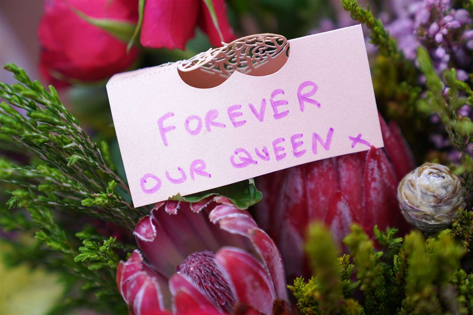 Some of those paying tribute at the gates described the Queen as ‘a grandmother to the nation’ (Kirsty O’Connor/PA)