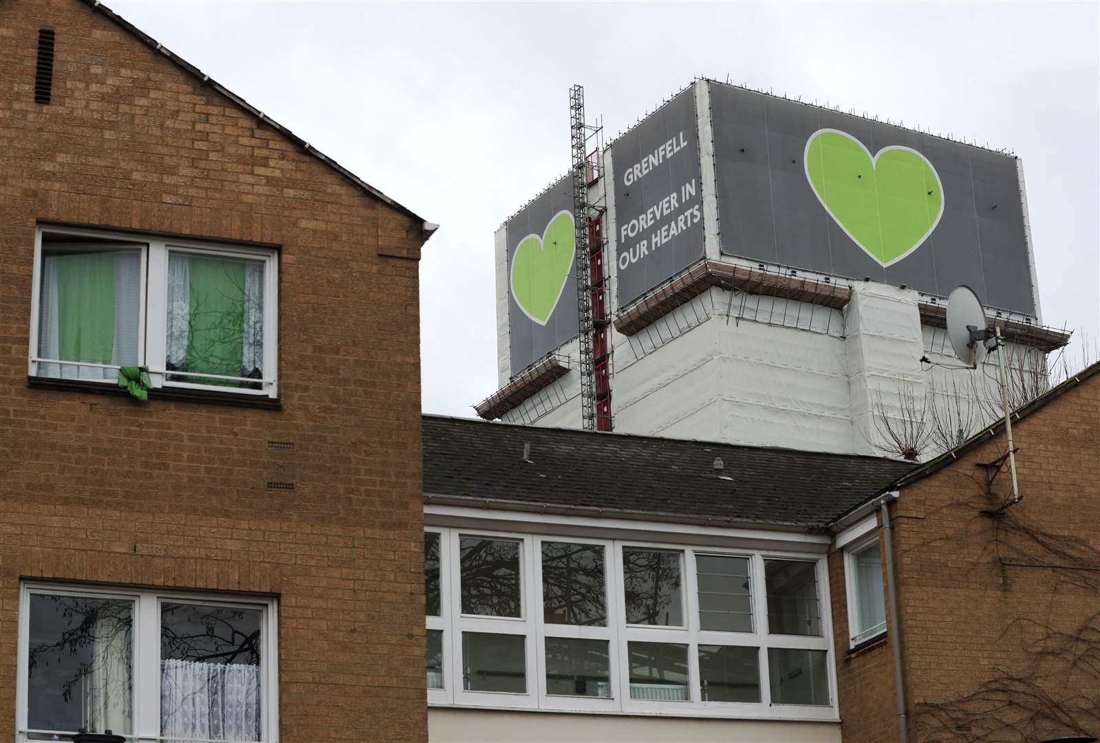 The Grenfell Tower looms behind Blechynden House in Kingsdown Close (Jonathan Brady/PA)