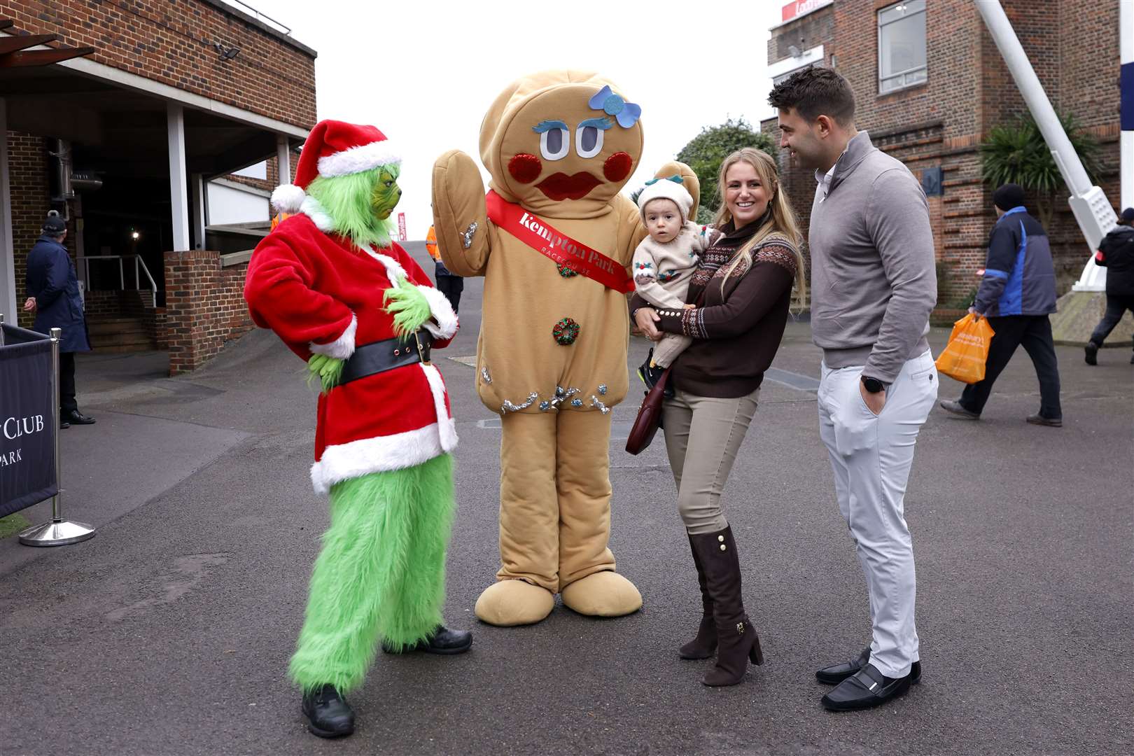 Racegoers pose with performers in Christmas fancy dress outfits on King George VI Chase Day at Kempton Park Racecourse in Surrey (Steven Paston for the Jockey Club/PA)