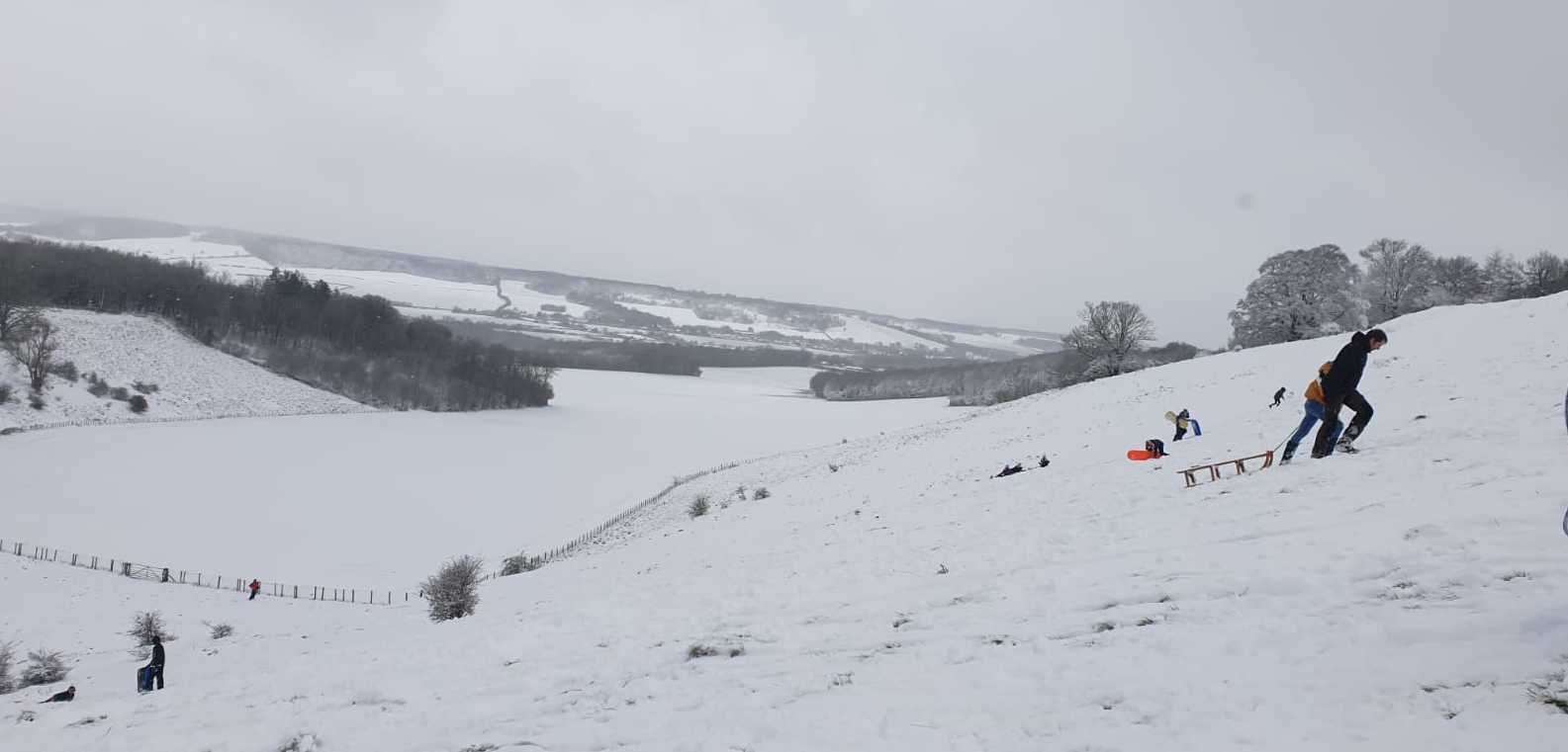 Sledging in the snow near the old racecourse in Wye