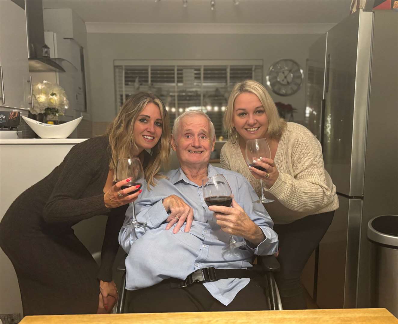 Barry Pitcher raises a glass with his daughters Jemma (left) and Carly