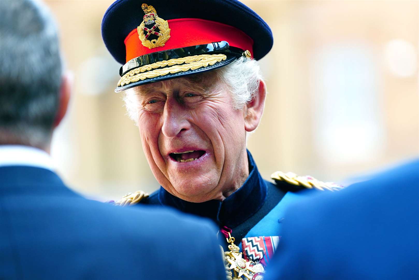 The King laughs with guests at the ceremony (Victoria Jones/PA)