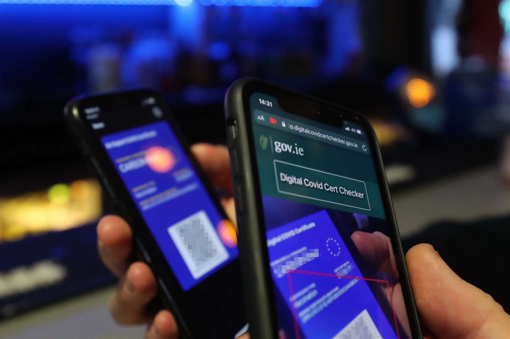 A Digital Covid Certificate Checker on a mobile phone is used to check the validity of a Covid passport in Dublin (Niall Carson/PA)