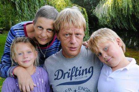 Four-year-old Nikkita Mills (bottom left) with aunt Christine, dad Adrian and brother Minali at home following her holiday accident in France.