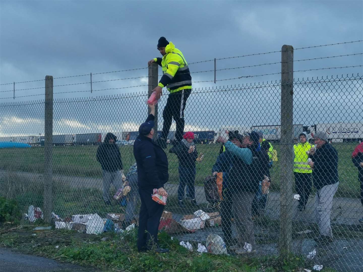 Food being handed over the fence to truckers at Manston on Christmas Eve morning
