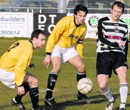 Deal's Scott Holden comes up against Erith Town defenders Dean Kearley and Aaron Hayrettin Picture: Terry Scott