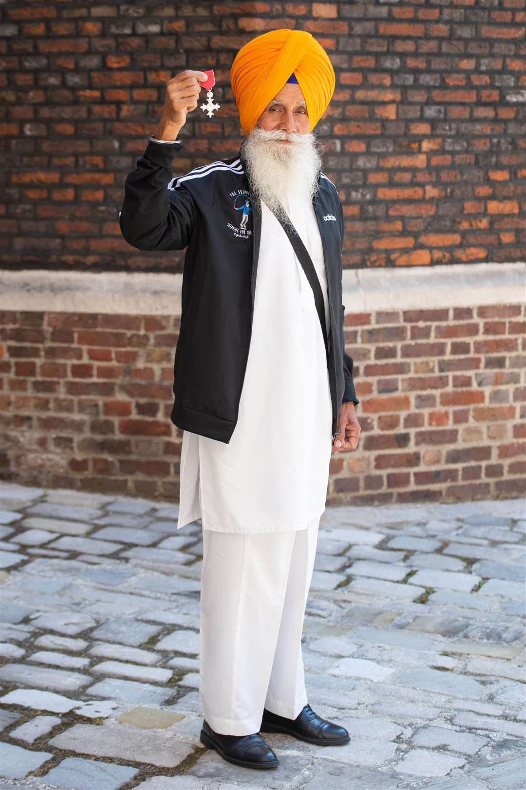 Rajinder Harzall with his MBE following an investiture ceremony at St James’s Palace (Dominic Lipinski/PA)