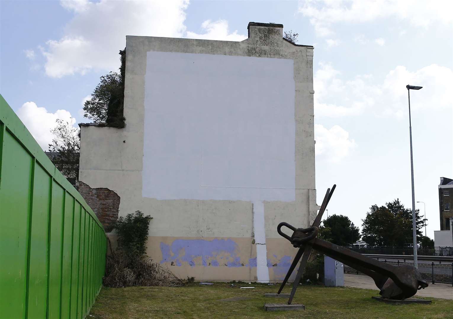 Blank canvas - the mural left with its white covering, photographed just after 11am today Picture: Matt Bristow.