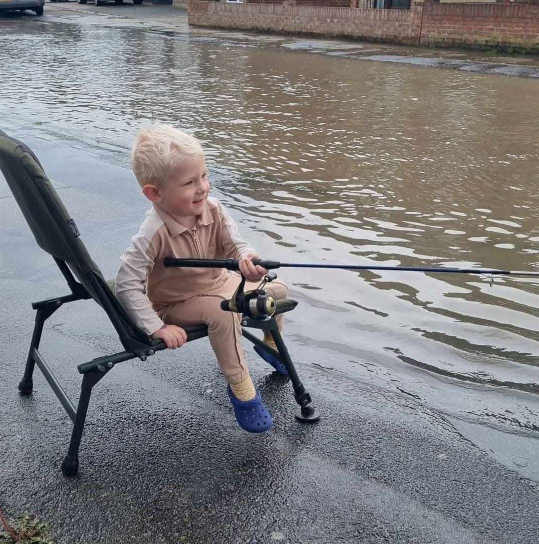 Fraser enjoying a bit of fishing during flooding in his grandparents' road in Gravesend