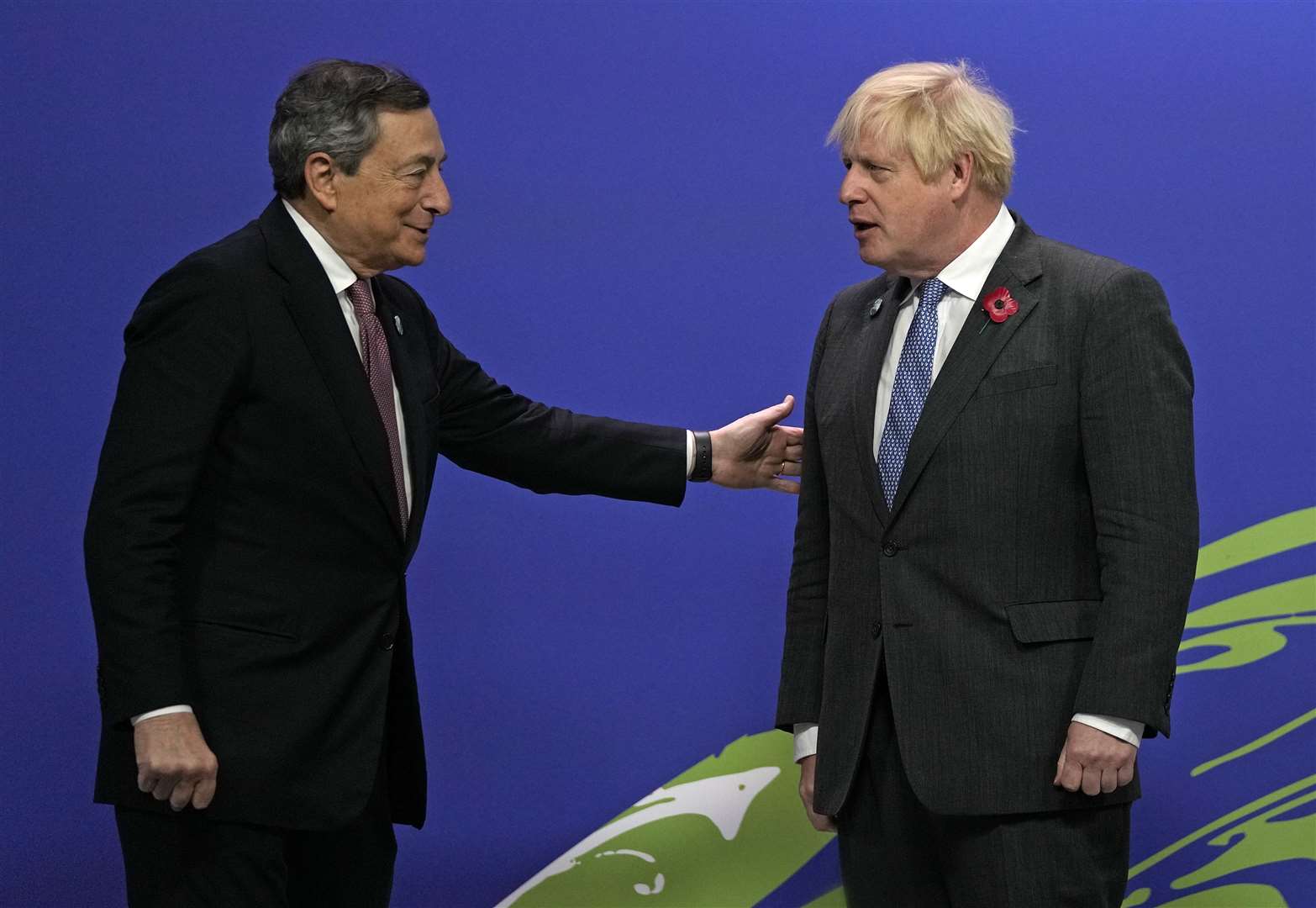 Prime Minister Boris Johnson (right) greets Italy’s Prime Minister Mario Draghi at the Cop26 summit (Alastair Grant/PA)