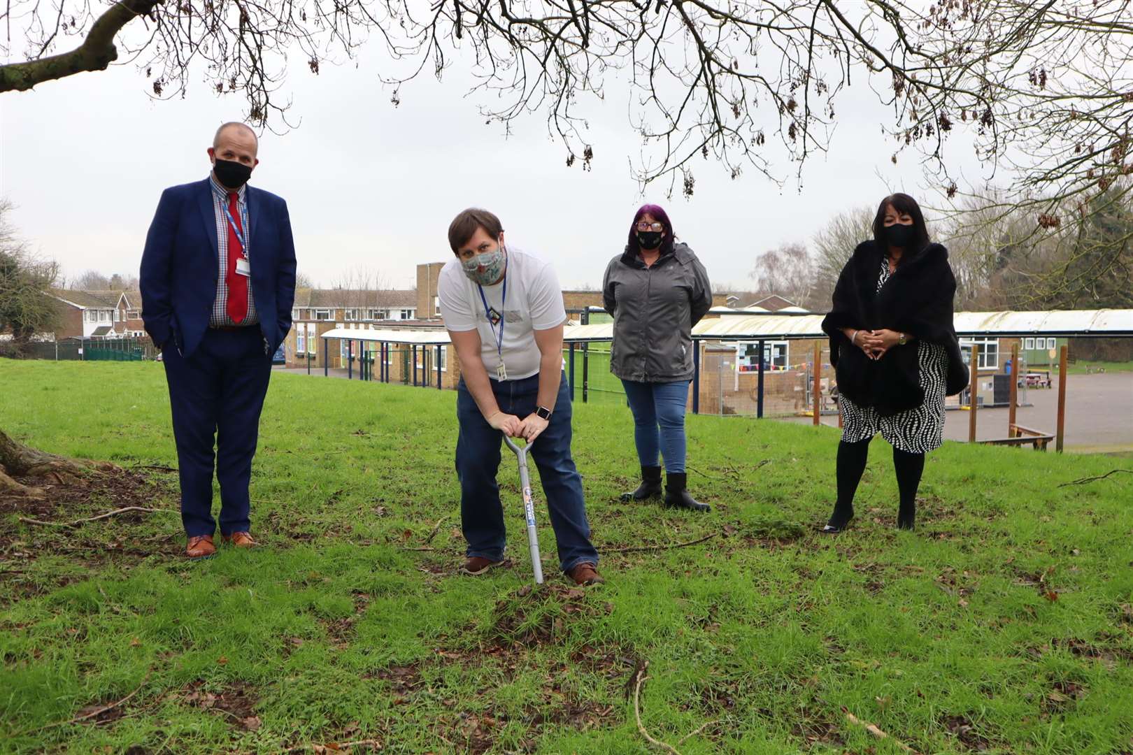 Sunny Bank head of school Darren Waters digging a hole for a time capsule at Murston with, from the left, Ryan Driver, Sarah Riggs and Debbie Wheeler
