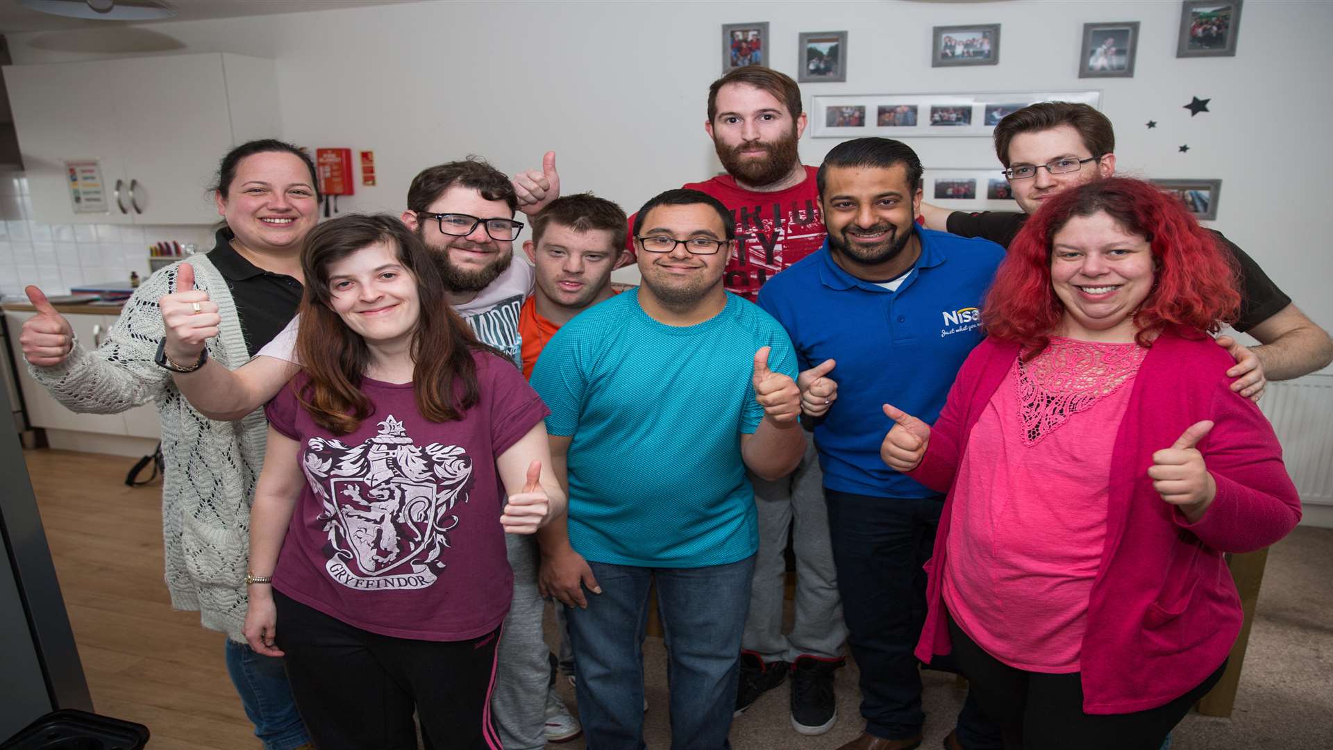 Jazz Goraya of Nisa presents a cheque to Kasbah. Pictured are staff member Sam Williams, residents Danielle Mason, Thomas Mays, Daniel Storey, Simon Binder, Scott Jones and Emily Knight and staff member Scott Matthews. Picture: Matthew Walker