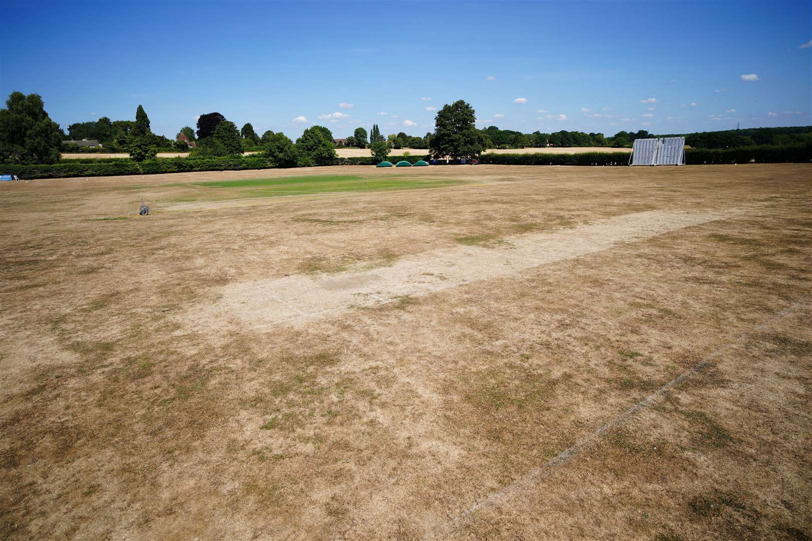 Parched grass at the cricket green in the village of Odiham (Ben Birchall/PA)